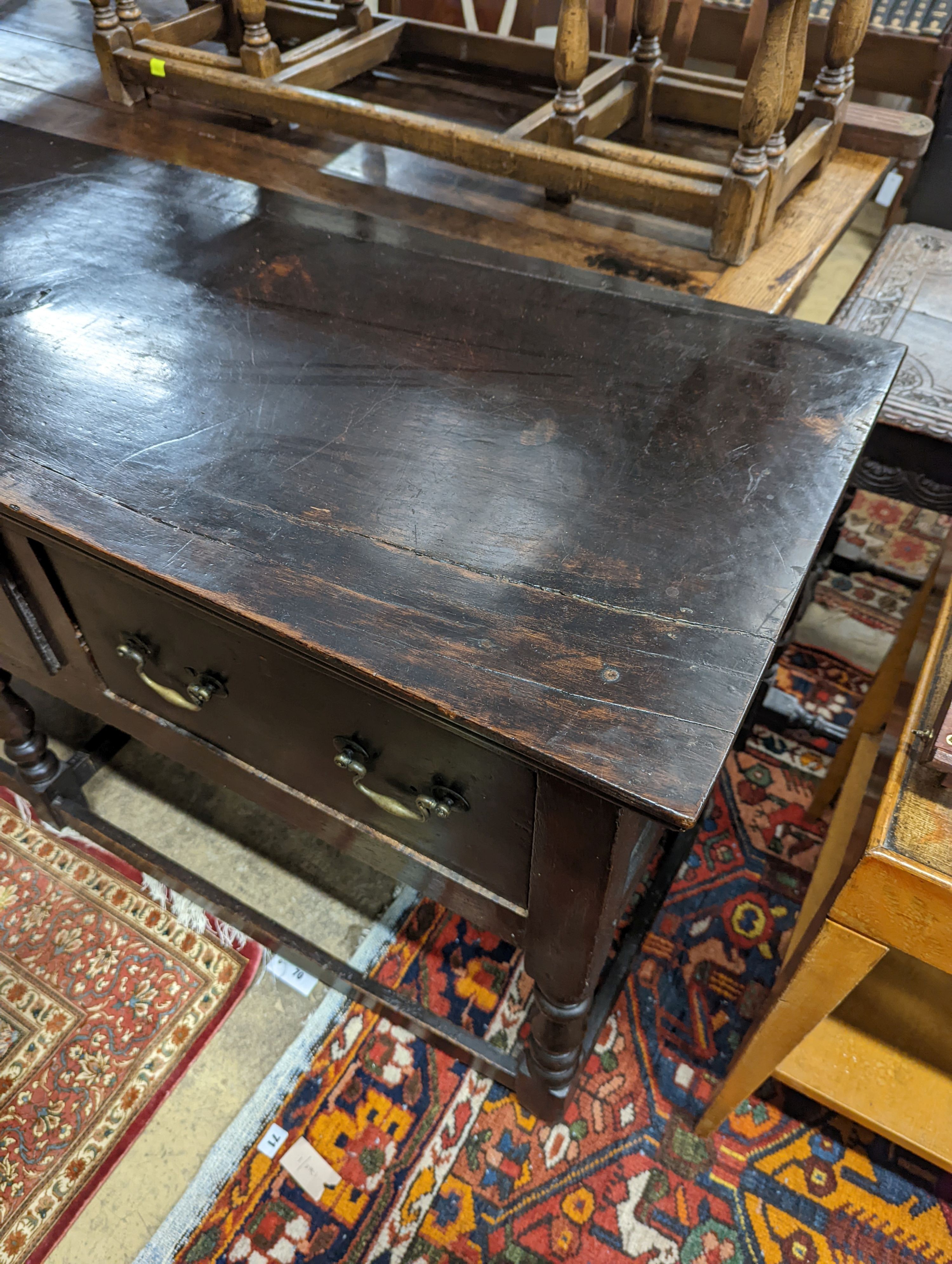 A George III oak low dresser base, length 175cm, depth 51cm, height 82cm